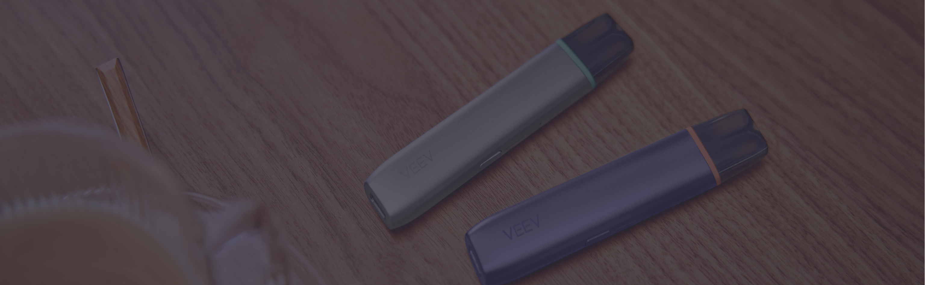 Garnet Red IQOS ILUMA i PRIME device above its charger